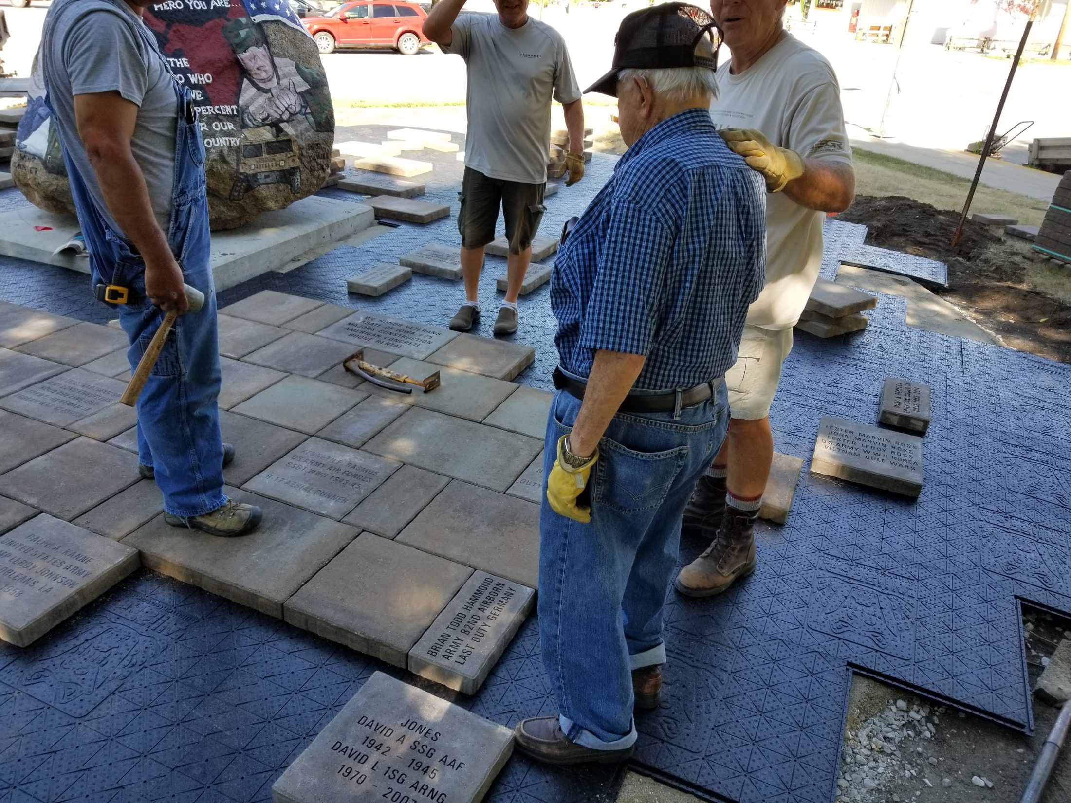 Bob Hammond assists in laying a paver he sponsored in memory of his son Brian.